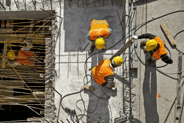 Three construction workers at construction site